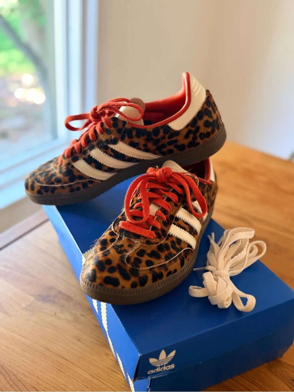 Adidas Originals samba sneakers in leopard print with red and white laces.